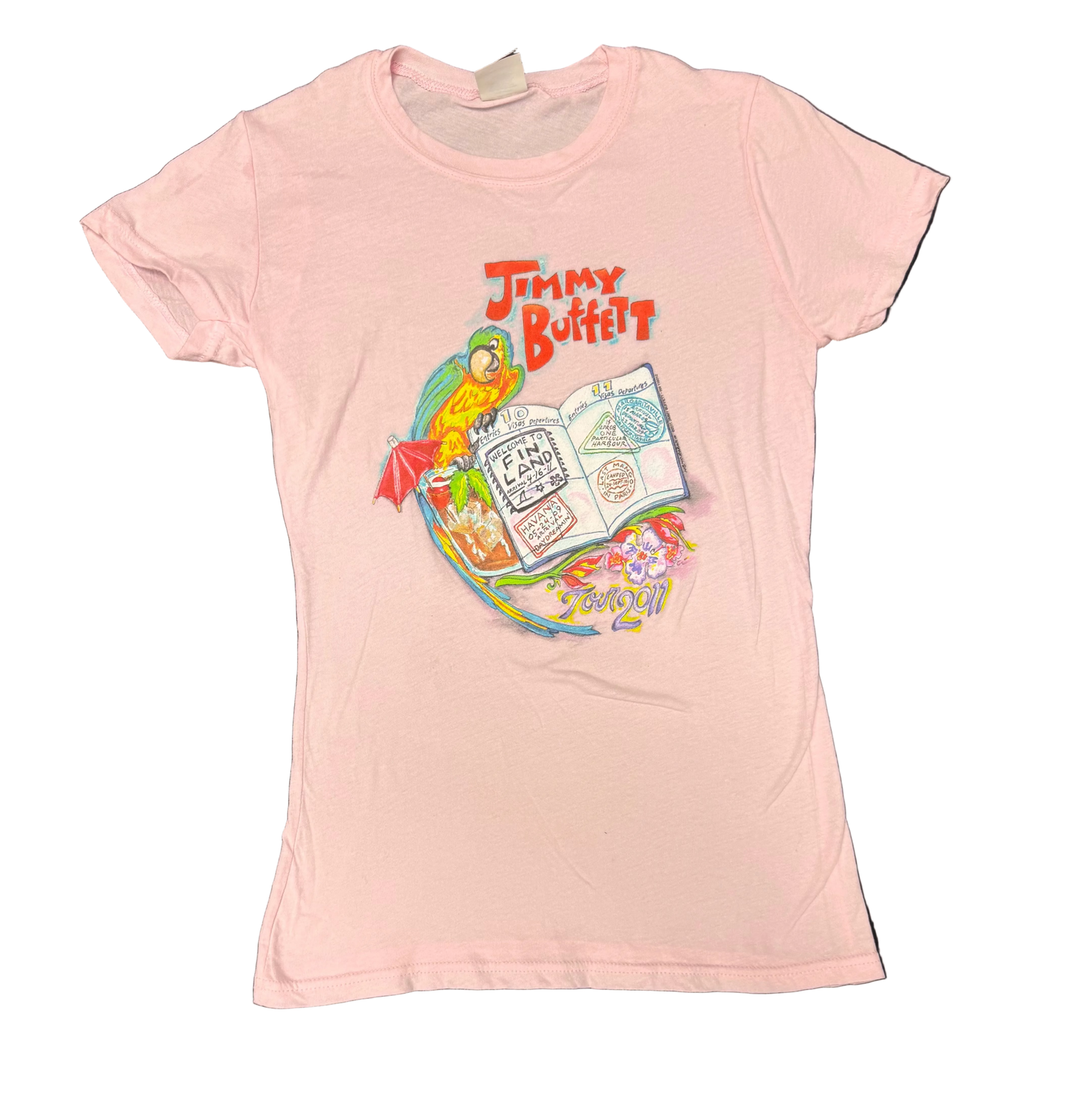 Light pink short sleeve Jimmy Buffett tee featuring a colorful tropical travel graphic with a parrot beside an open passport marked “Welcome to Fin Land.” A tropical drink and beach inspired details surround the artwork, with “Jimmy Buffett” above and “Tour 2011” below.