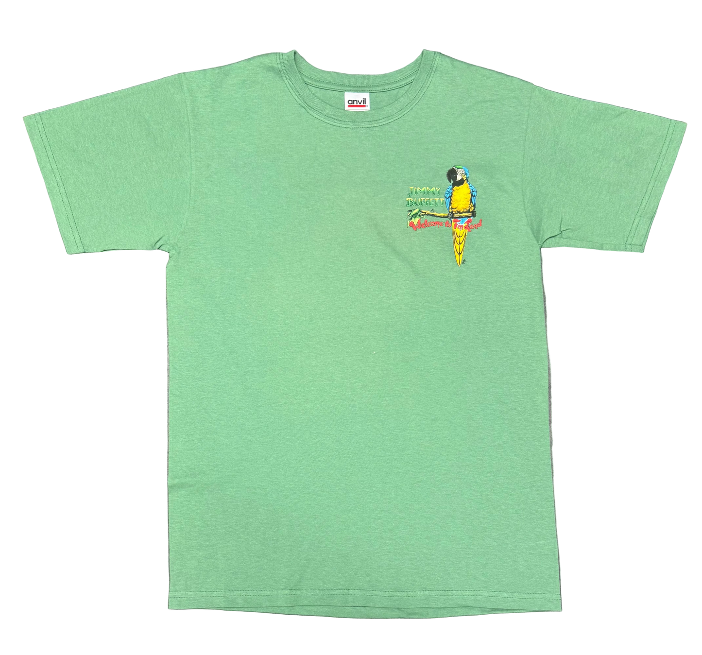 Green short sleeve Jimmy Buffett tee featuring a small chest graphic of a blue and yellow macaw perched on a branch. “Jimmy Buffett” appears beside the parrot, with colorful “Welcome to Fin Land” lettering below.