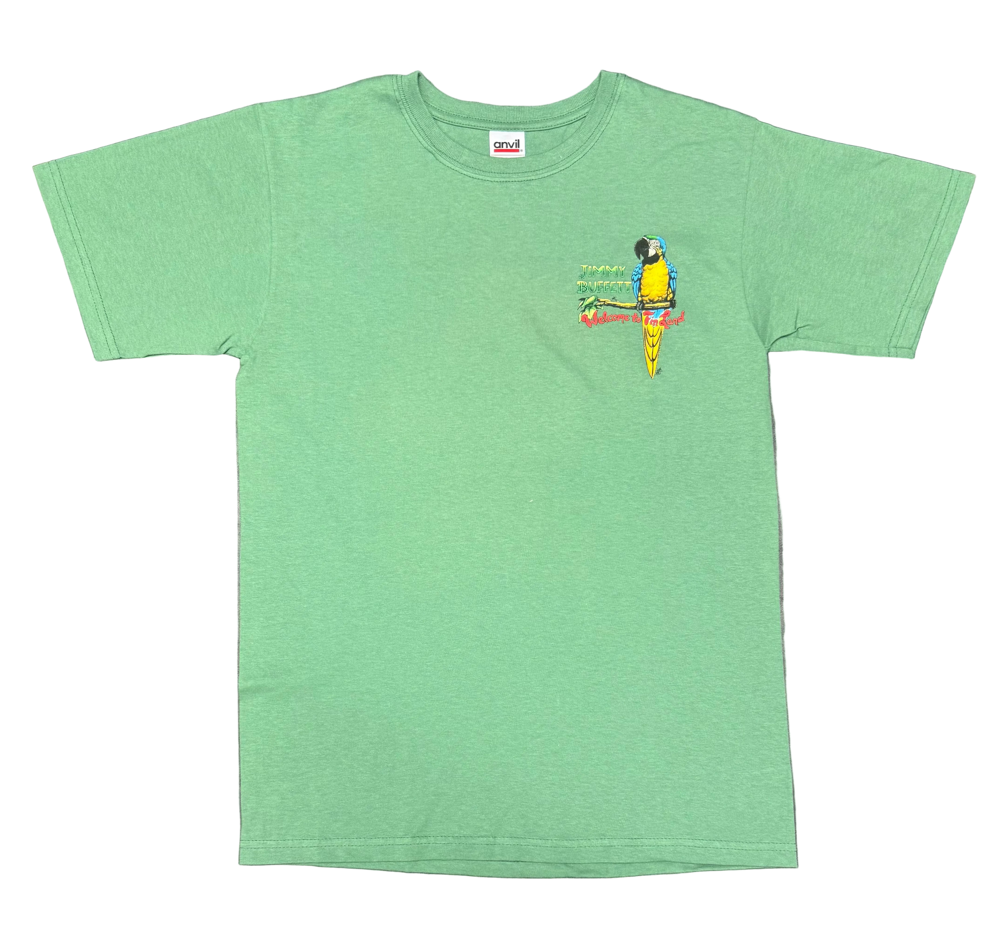 Green short sleeve Jimmy Buffett tee featuring a small chest graphic of a blue and yellow macaw perched on a branch. “Jimmy Buffett” appears beside the parrot, with colorful “Welcome to Fin Land” lettering below.