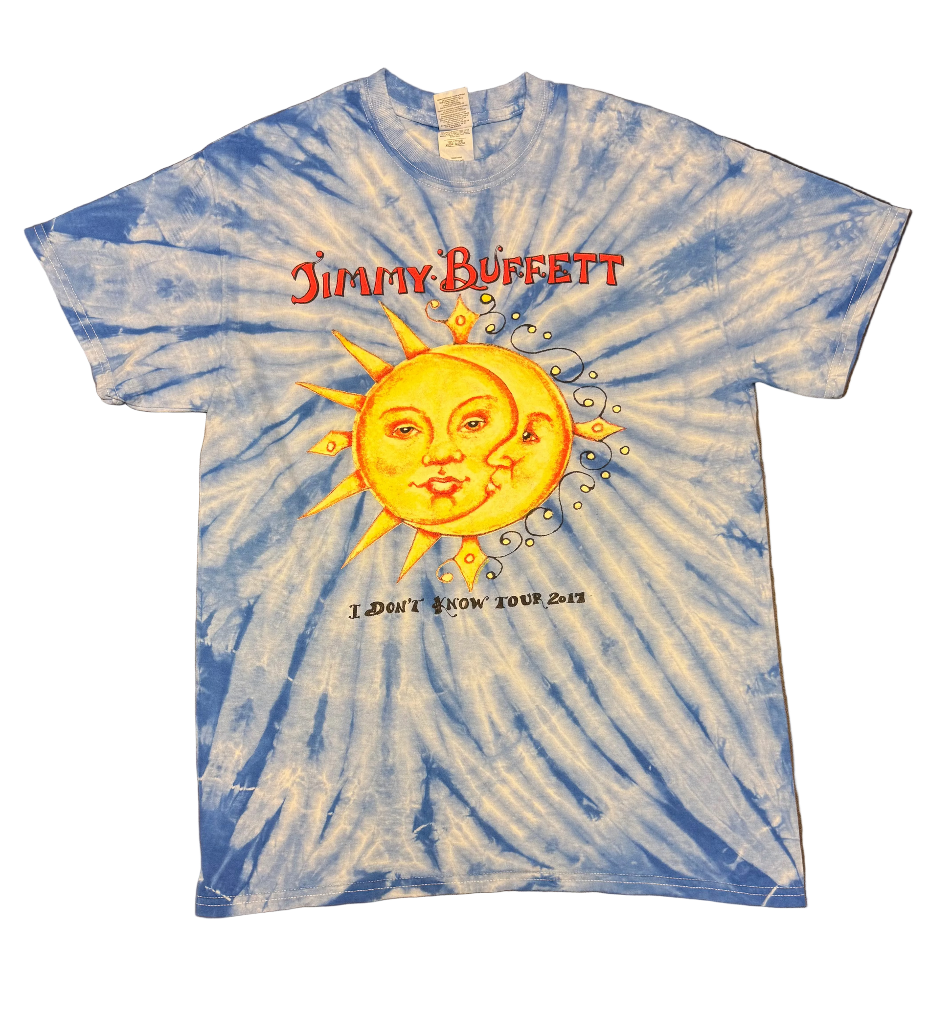 Blue and white tie dye short sleeve Jimmy Buffett tee featuring a large yellow sun and crescent moon face graphic at center. Red “Jimmy Buffett” lettering appears above the artwork, with “I Don’t Know Tour 2017” printed below.