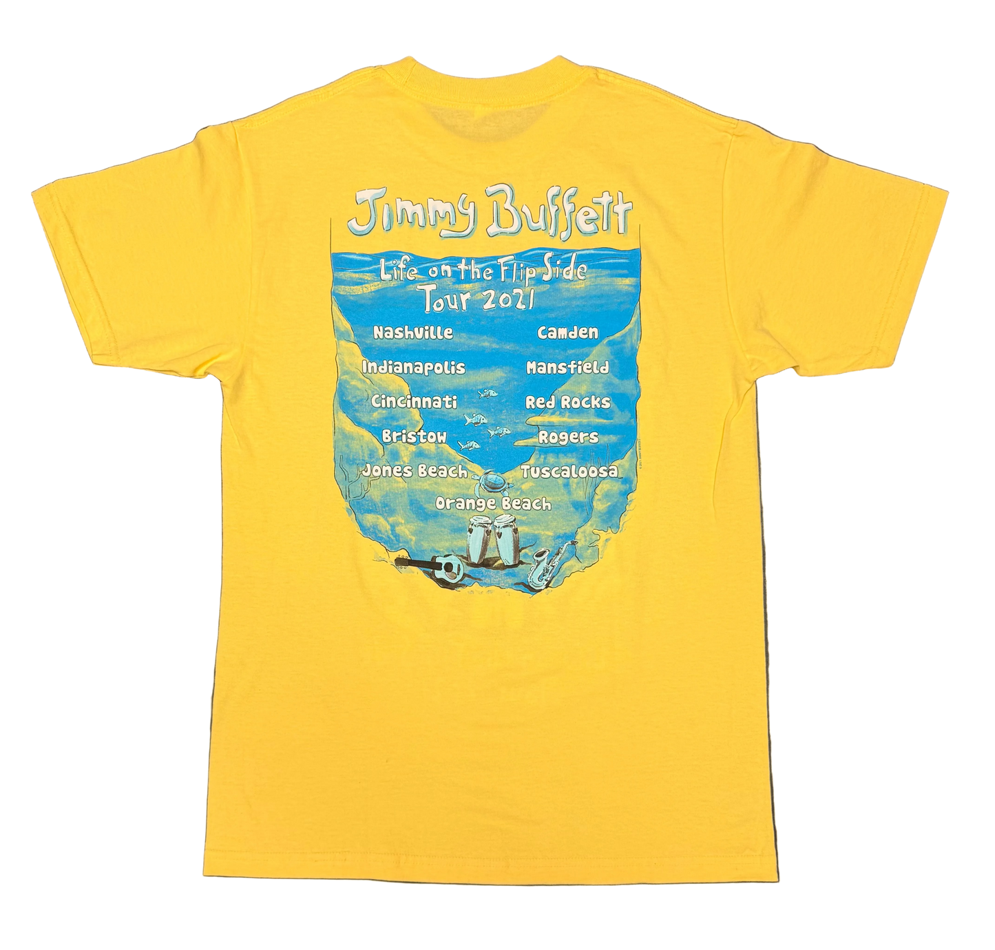 Back of a bright yellow short sleeve Jimmy Buffett tee featuring an underwater scene with “Jimmy Buffett” and “Life on the Flip Side Tour 2021” lettering above a list of tour cities. Fish, a sea turtle, guitar, congas, and saxophone complete the ocean themed design.