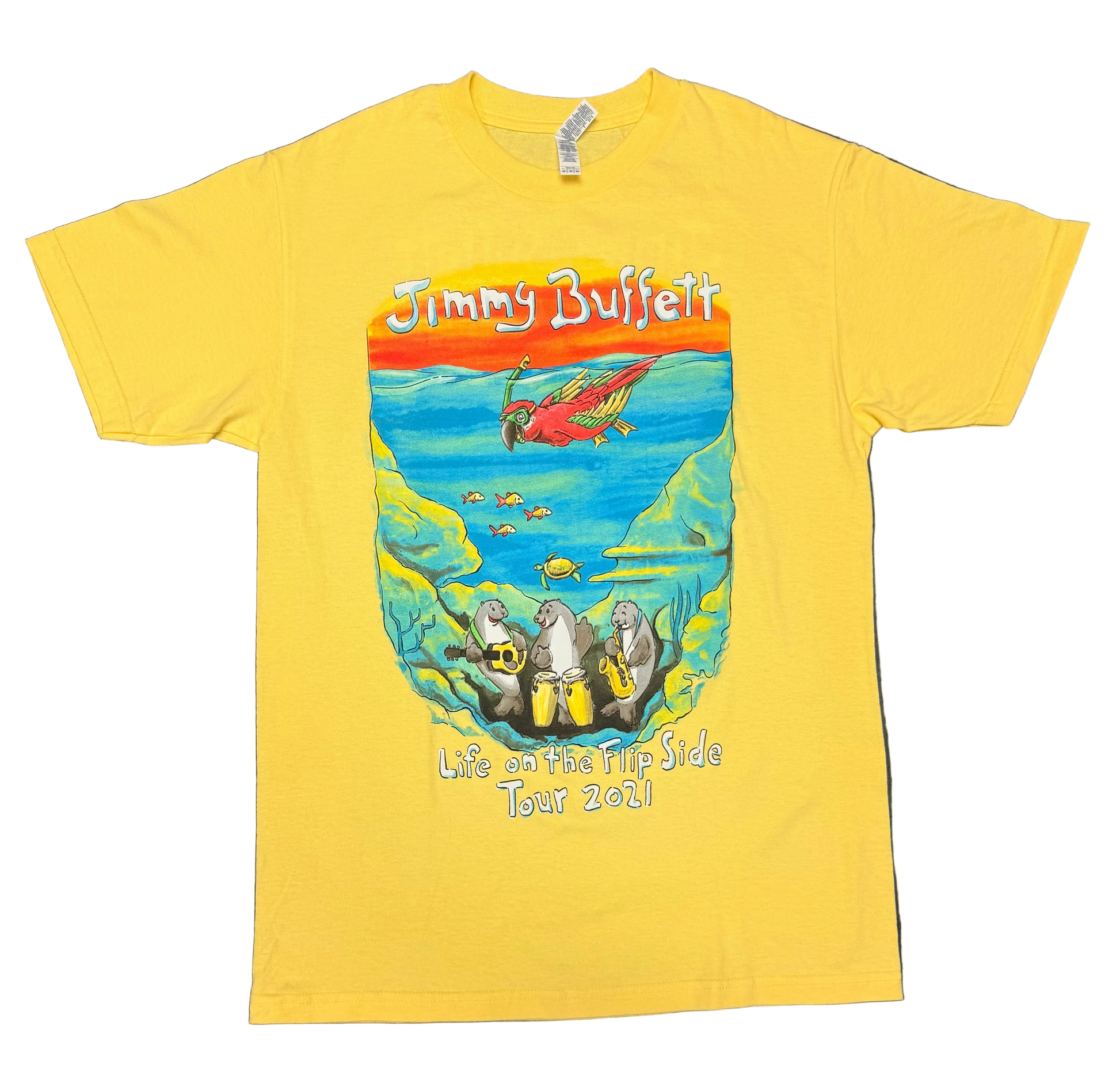 Bright yellow short sleeve Jimmy Buffett tee featuring a colorful underwater scene with a red parrot swimming above tropical fish and a sea turtle. Three manatees play guitar, congas, and saxophone along the ocean floor, with “Jimmy Buffett” above and “Life on the Flip Side Tour 2021” below.