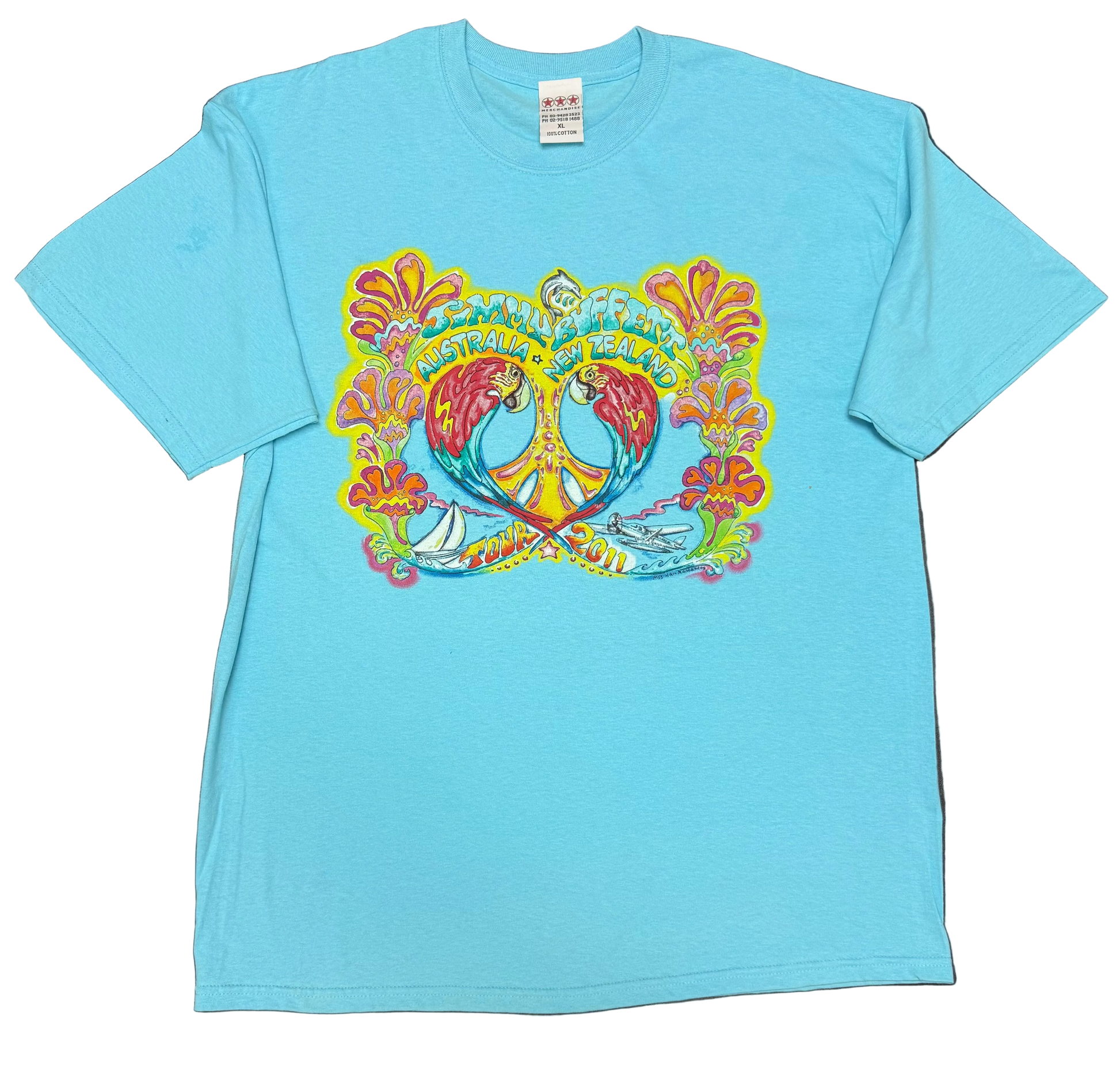 Aqua blue short sleeve Jimmy Buffett tee featuring two colorful macaws facing each other around a large yellow peace sign, framed by bright tropical flowers. “Jimmy Buffett Australia + New Zealand” appears across the top, with a sailboat, seaplane, and “Tour 2011” artwork along the bottom.