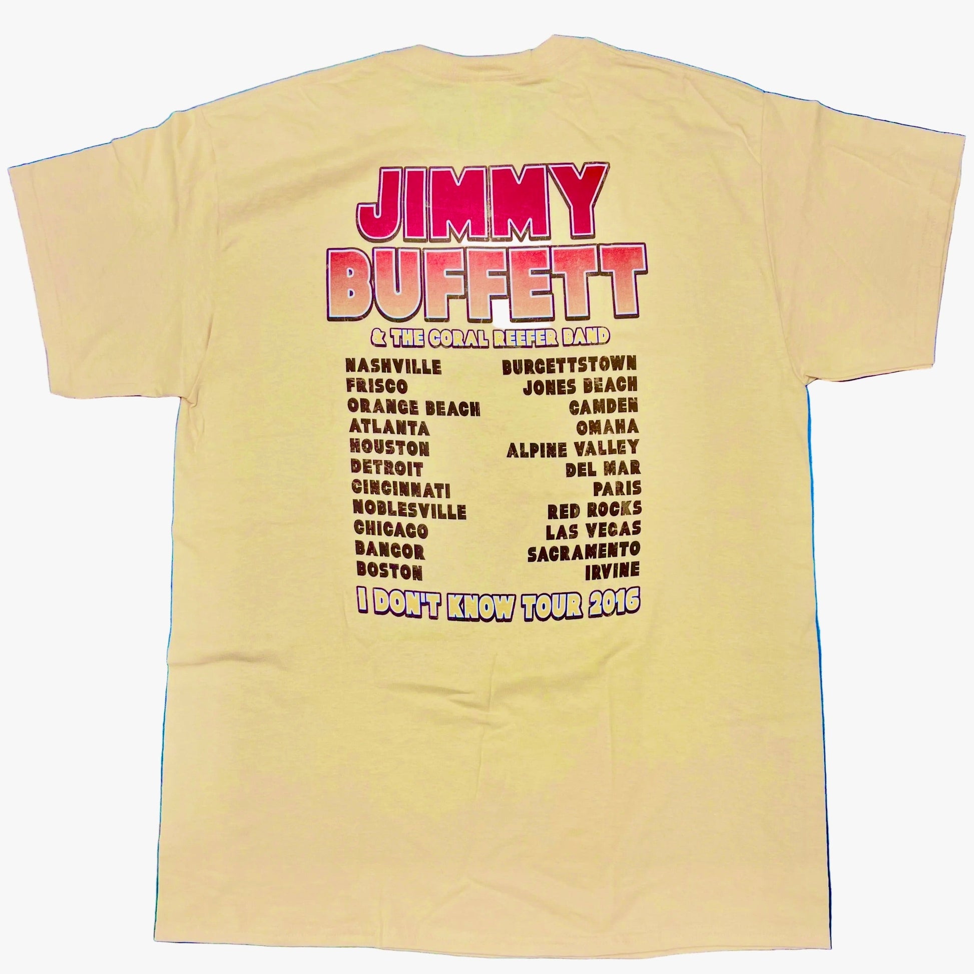 Back of a light yellow short sleeve Jimmy Buffett tee featuring large red “Jimmy Buffett” lettering above “& The Coral Reefer Band.” Two columns of 2016 tour cities appear below, with “I Don’t Know Tour 2016” printed at the bottom.