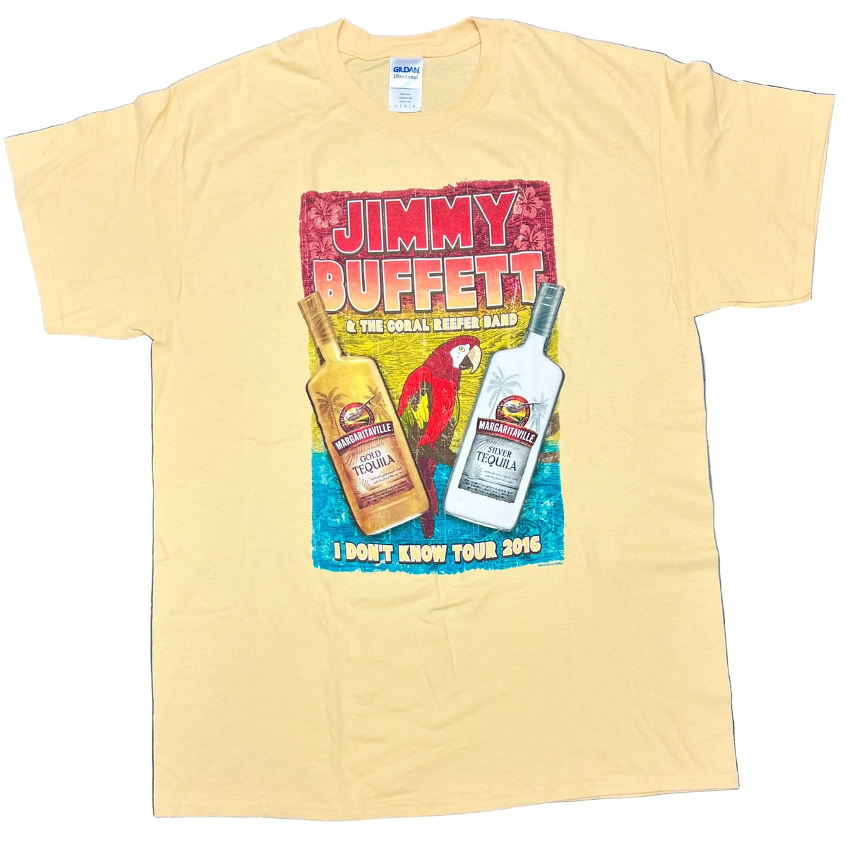 Light yellow short sleeve Jimmy Buffett tee featuring bold red and white “Jimmy Buffett” lettering above a tropical graphic with a red parrot between bottles of Margaritaville Gold Tequila and Silver Tequila. “I Don’t Know Tour 2016” appears along the bottom.