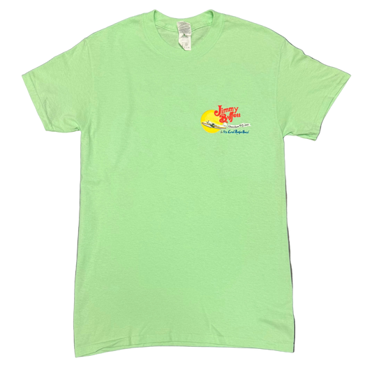 Light green short sleeve Jimmy Buffett tee featuring a small left chest graphic with red “Jimmy Buffett” lettering above a yellow sun and a seaplane. “I Don’t Know Tour 2017” appears in the center, with “and The Coral Reefer Band” below.