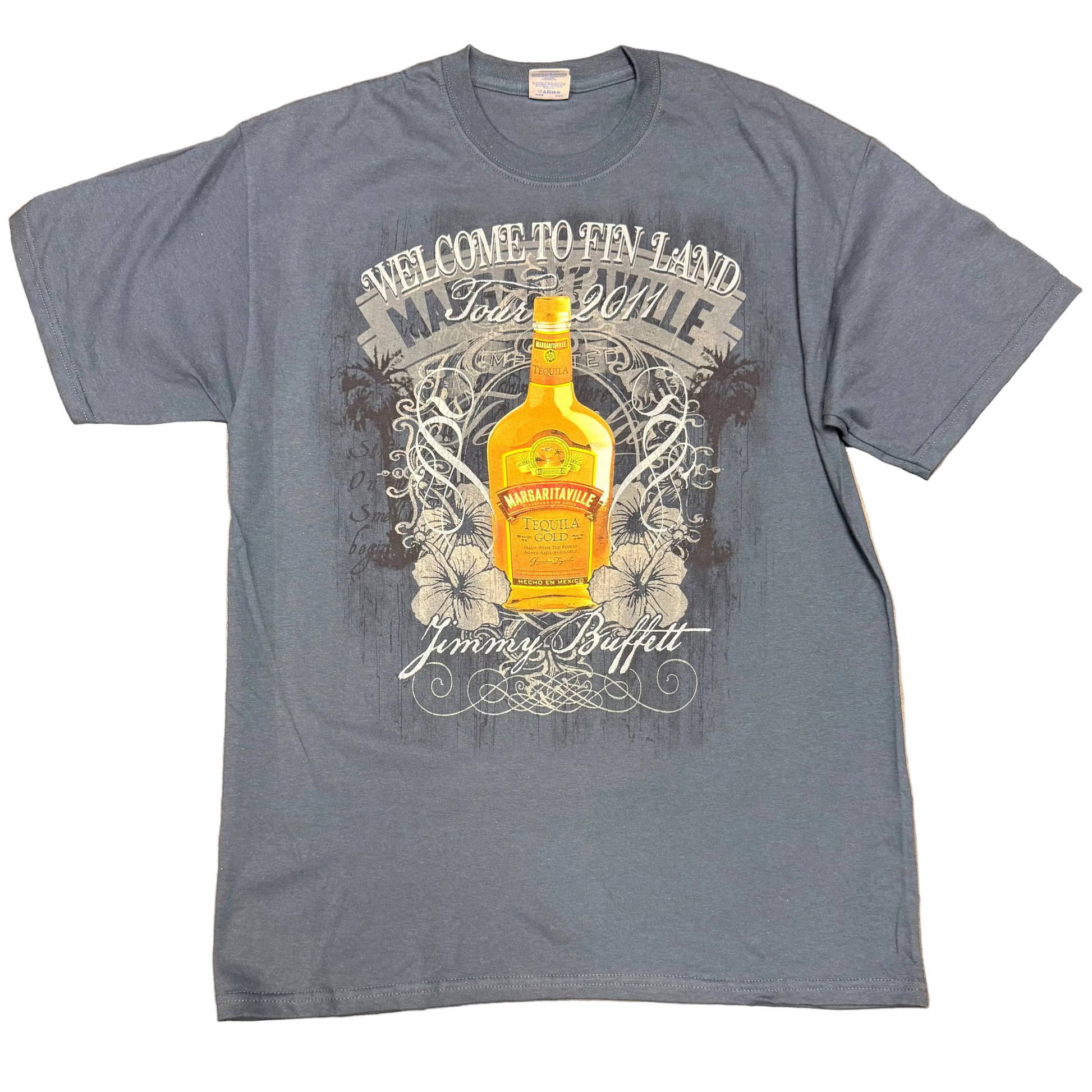 Charcoal blue slate short sleeve Jimmy Buffett tee featuring a large bottle of Margaritaville Gold Tequila centered over distressed vintage style graphics, hibiscus flowers, and ornate script. “Welcome to Fin Land Tour 2011” appears across the top, with Jimmy Buffett lettering below.