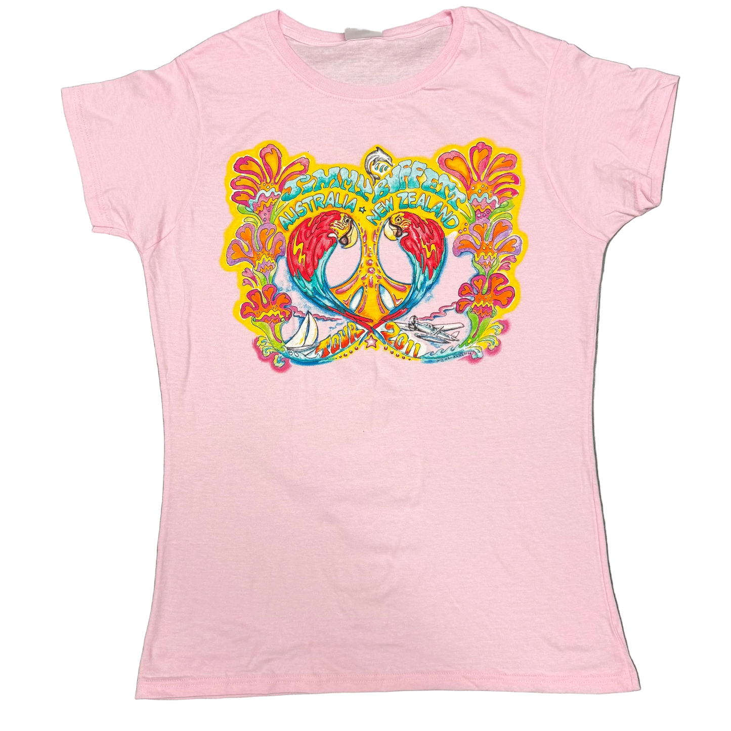 Light pink women’s short sleeve Jimmy Buffett tee featuring two colorful macaws facing each other around a yellow peace sign, framed by bright tropical flowers. “Jimmy Buffett Australia + New Zealand” appears across the top, with a sailboat, seaplane, and “Tour 2011” artwork along the bottom.