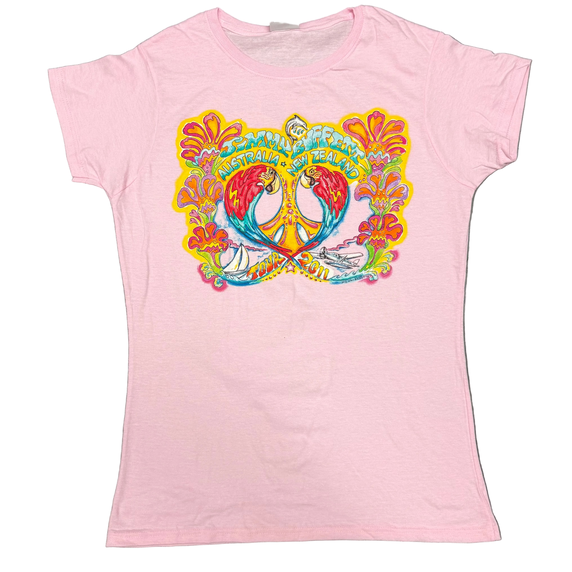Light pink women’s short sleeve Jimmy Buffett tee featuring two colorful macaws facing each other around a yellow peace sign, framed by bright tropical flowers. “Jimmy Buffett Australia + New Zealand” appears across the top, with a sailboat, seaplane, and “Tour 2011” artwork along the bottom.