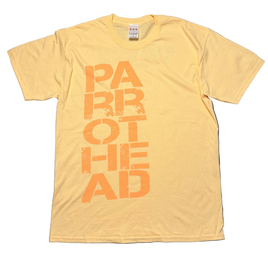 Light yellow short sleeve Jimmy Buffett tee featuring oversized distressed orange lettering spelling “Parrothead” stacked vertically down the front.