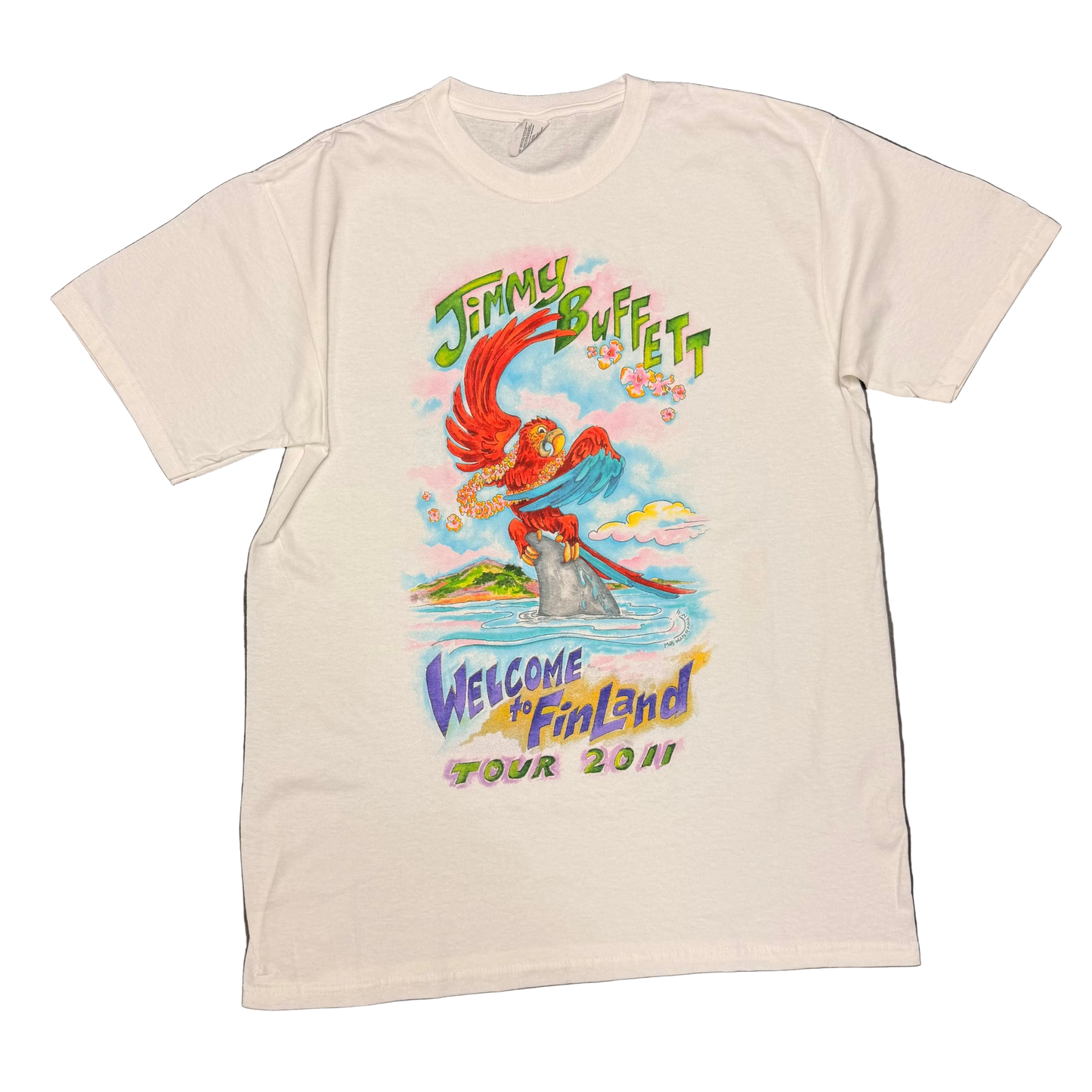 White short sleeve Jimmy Buffett tee featuring a colorful red parrot perched on a shark fin in the ocean, with a tropical island and clouds in the background. Green “Jimmy Buffett” lettering appears above the artwork, with “Welcome to Fin Land Tour 2011” printed below in purple, yellow, pink, and green.