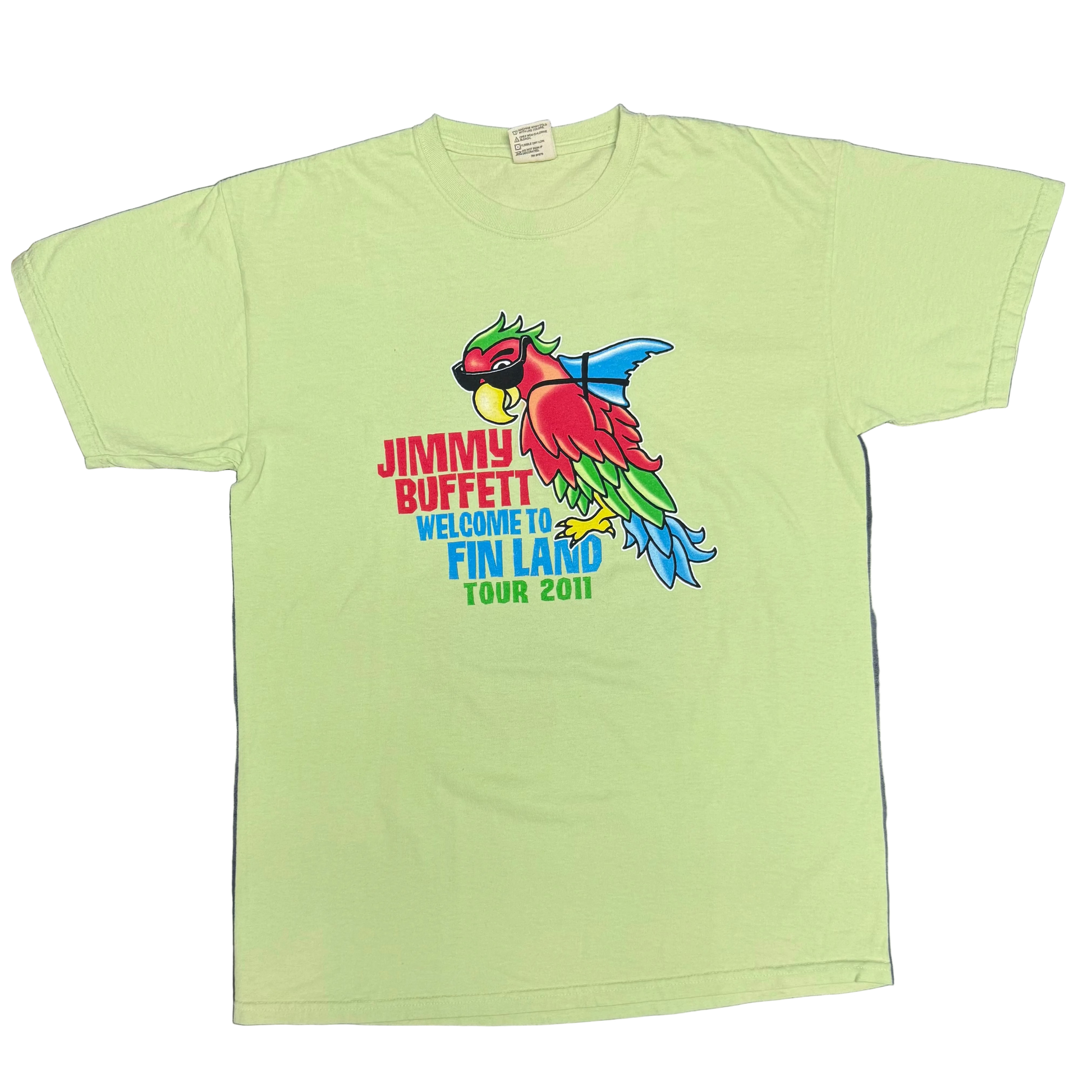 Light green short sleeve Jimmy Buffett tee featuring a colorful parrot wearing sunglasses with a blue shark fin strapped to its back. Red “Jimmy Buffett” lettering appears beside the artwork, with blue “Welcome to Fin Land” and “Tour 2011” text below.