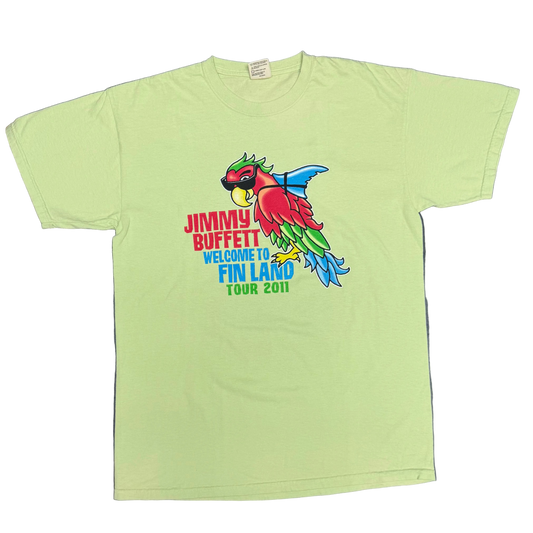 Light green short sleeve Jimmy Buffett tee featuring a colorful parrot wearing sunglasses with a blue shark fin strapped to its back. Red “Jimmy Buffett” lettering appears beside the artwork, with blue “Welcome to Fin Land” and “Tour 2011” text below.